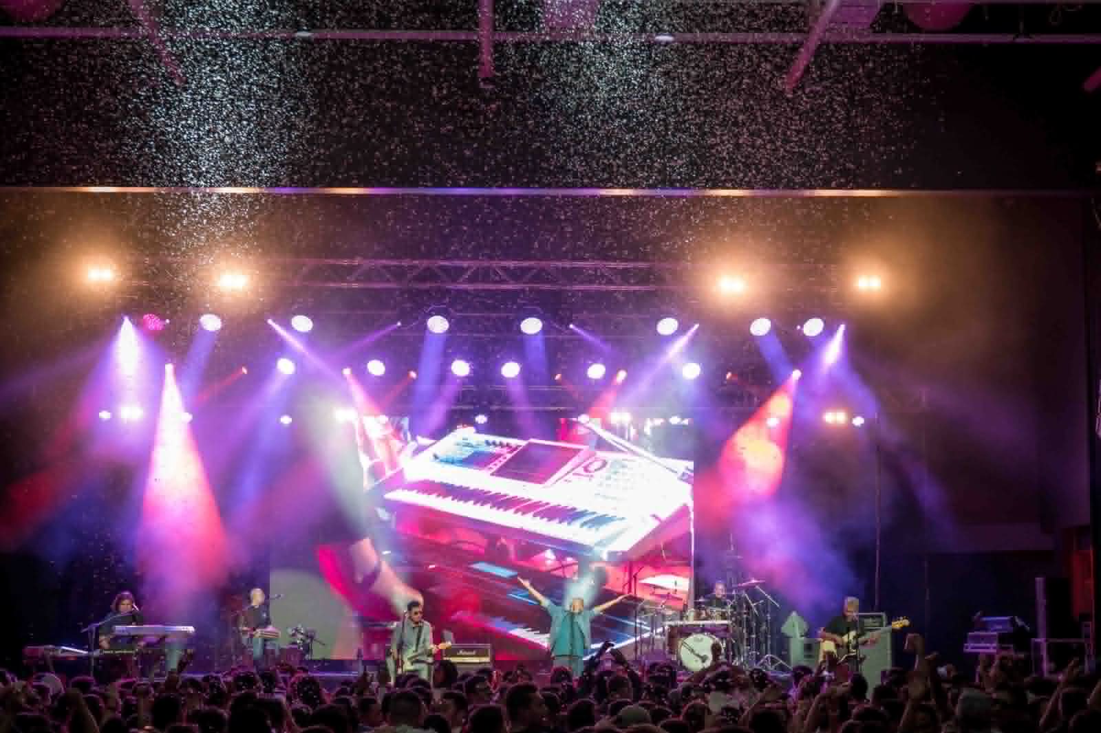 Stage view over the crowd with pink and purple lights
